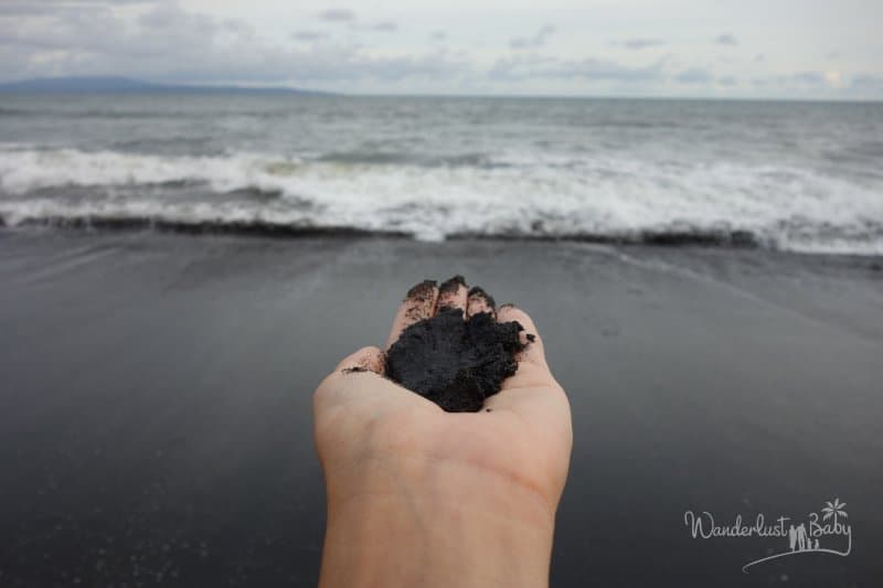 Schwarzer Sand in der Hand